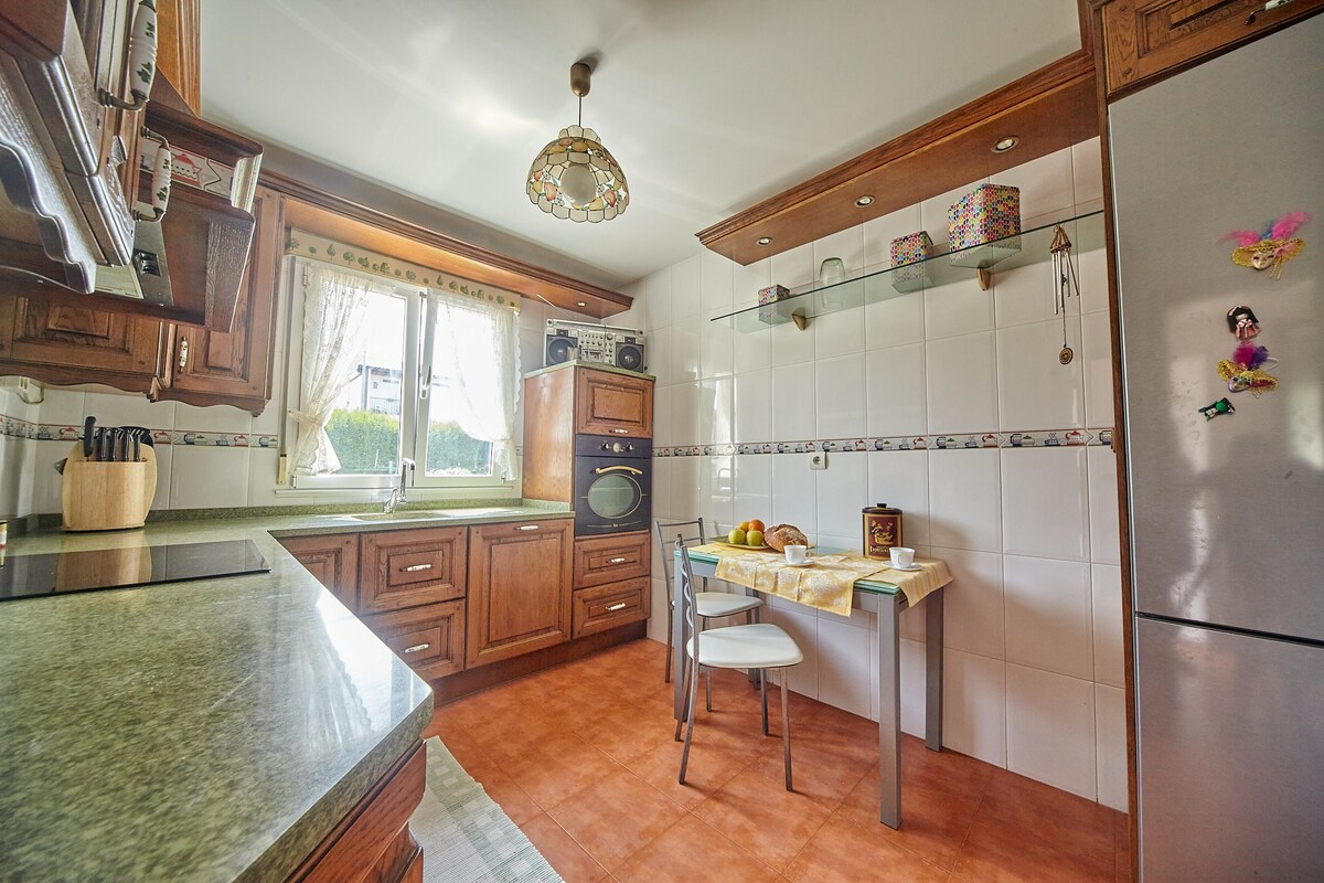 Cocina equipada con nevera, horno y utensilios de cocina